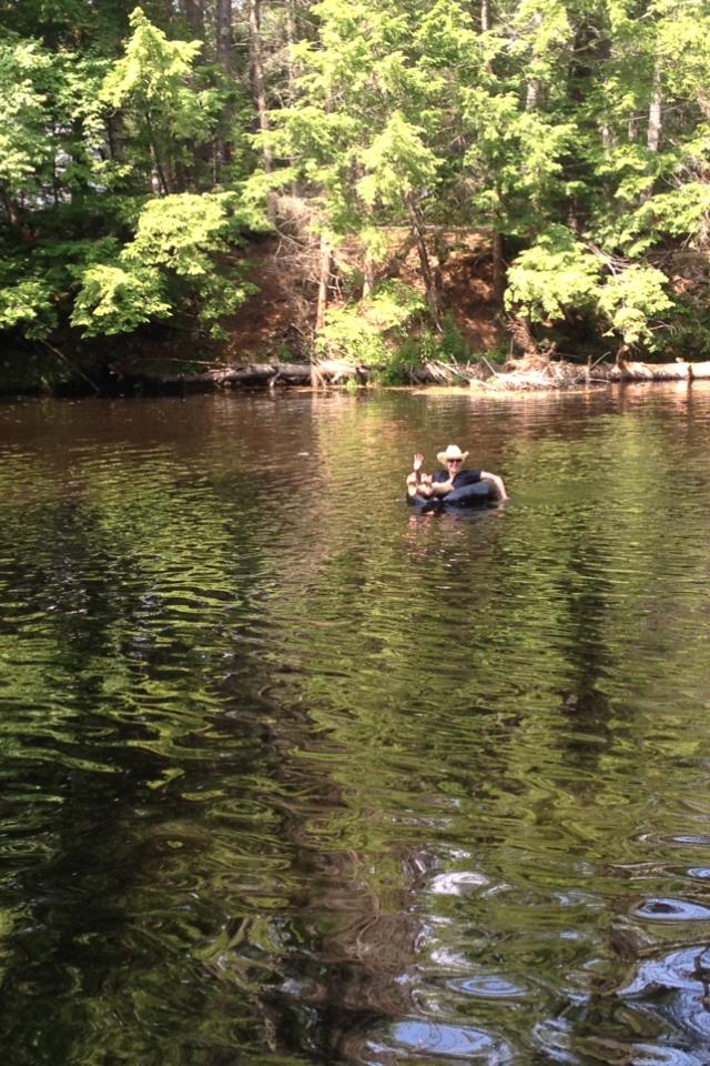 Man Tubing Down River